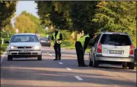  ?? (AP/Czarek Sokolowski) ?? Polish police officers stop vehicles last week in Krynki, Poland, an area along the border with Belarus.