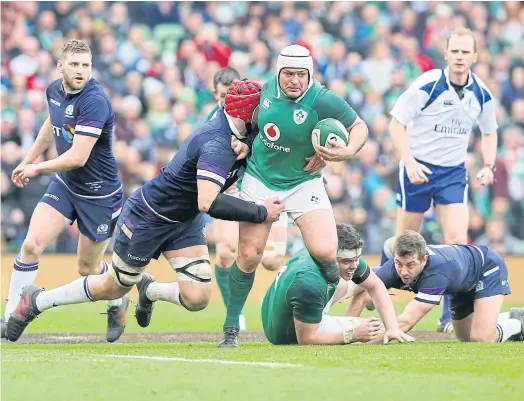  ??  ?? Ireland’s Rory Best, centre, is tackled by Scotland’s Grant Gilchrist during their Six Nations match last week.