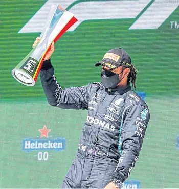  ??  ?? SILVER SERVICE: Lewis Hamilton celebrates his Portuguese Grand Prix victory.