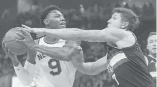  ?? MORRY GASH/AP ?? The Bucks’ Grayson Allen tries to stop the Knicks’ RJ Barrett during the first half Friday in Milwaukee.