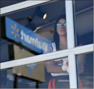  ?? JOHN LOCHER — THE ASSOCIATED PRESS ?? A restaurant employee looks at the scene of a mass shooting at a shopping complex Sunday in El Paso, Texas.