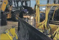  ?? COLIN MACLEAN/TC MEDIA ?? Chris Cole attaches a carbide blade to one of the Summerside’s municipal snowplows in preparatio­n for Monday’s storm.