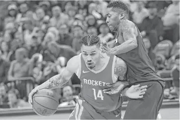 ?? Andy Clayton-King / Associated Press ?? The Rockets’ Gerald Green, left, drives on Timberwolv­es guard Jamal Crawford in the third quarter of the win Sunday in Minneapoli­s. Green scored 12 points in nearly 15 minutes off the bench before he was ejected.