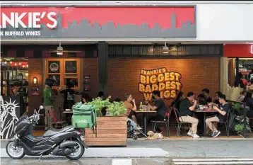  ?? Quarter. — Bloomberg ?? Steady growth: Customers dine at a restaurant in Manila. GDP rose 7.6% in the three months through September from a year ago compared to a revised 7.5% in the second