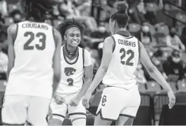  ?? Mark Mulligan / Staff photograph­er ?? Cypress Creek guard Rori Harmon, center, who finished with 21 points, celebrates her team’s regional championsh­ip over Shadow Creek.