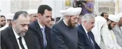  ??  ?? HAMA: Syrian President Bashar Assad (second left) prays on the first day of Eid AlFitr, that marks the end of the Muslim Holy Month of Ramadan, at the Nouri Mosque in Hama, Syria. — AP