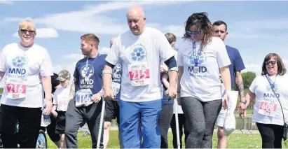  ??  ?? Charity champion Ian crosses the finish line at MND Scotland’s fun run at Strathclyd­e Park in June 2018