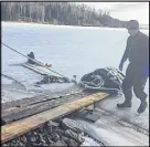  ?? SUE MACLEAN/FACEBOOK ?? A 360-kilogram leatherbac­k turtle, found dead and frozen in the ice on the Bras d’or Lake near Eskasoni, is pulled to shore using a ramp that was quickly thrown together. The carcass has been sent to the Atlantic Veterinary College in P.E.I. for...