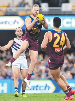  ?? Picture: GETTY ?? Brisbane’s Daniel Rich marks against Fremantle at the Gabba.