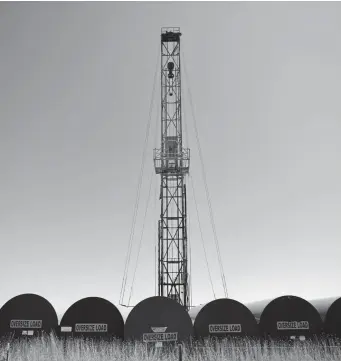  ?? Joe Amon, The Denver Post ?? A rig and tanks for well servicing stand along Weld County Road 49, known locally as the Kersey Cutoff. Tax proceeds from energy production helped fund the road’s $110 million upgrade in 2017.