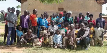  ?? — AFP photos ?? Hasahya (centre) with some of his wives, children and grandchild­ren outside their family home.