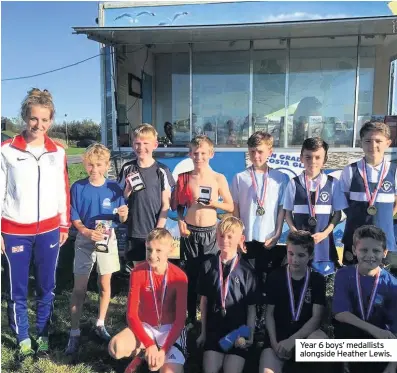  ??  ?? Year 6 boys’ medallists alongside Heather Lewis.