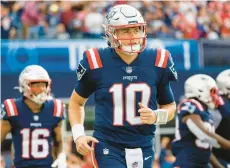  ?? GREG M. COOPER/AP ?? Patriots quarterbac­k Mac Jones looks to the scoreboard during the first half against the Colts on Nov. 6 in Foxborough, Mass.