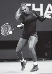  ?? CLIVE BRUNSKILL Getty Images ?? Serena Williams returns a hot on the way to a 6-3, 6-1 victory over No. 5-seeded Elina Svitolina in the semifinals.