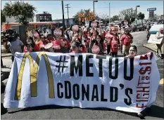  ?? RICHARD VOGEL — THE ASSOCIATED PRESS FILE ?? McDonald’s workers carry a banner and march towards a McDonalds in south Los Angeles. Roughly a third of American workers say they’ve changed how they act at work in the past year, as the #MeToo movement has focused the nation’s attention on sexual misconduct. That’s according to a new poll of full- or part-time workers released Tuesday by The Associated Press-NORC Center for Public Affairs Research and the software company SAP.