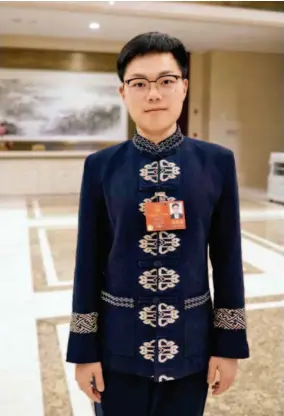  ??  ?? Xiang Weiyi, a millennial deputy to the National People’s Congress who works as a village official in Cili County, Hunan Province, pays special attention to how he can provide qualified personnel for the rural vitalizati­on strategy. by Wan Quan