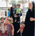  ??  ?? Women and children at a desert camp – men have been rounded up by the militias