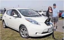  ??  ?? Robert Haran and Mari Viner-Haran charging their Nissan Leaf at Crissy Field during National Plug-In Day.