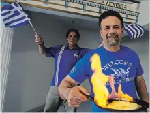  ?? CLIFFORD SKARSTEDT/EXAMINER ?? City councillor­s Don Vassiliadi­s and Dean Pappas prepare flaming saganaki cheese on Wednesday at Peterborou­gh’s Holy Trinity Greek Orthodox Church to promote the Greek Festival Sunday aon t the church Parkhill Rd. E.