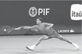  ?? GEOFF BURKE/USA TODAY SPORTS ?? Carlos Alcaraz reaches for a forehand against Lorenzo Musetti during the Miami Open on Tuesday in Miami Gardens, Fla.