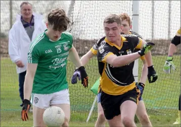  ??  ?? Seán Doyle of Naomh Eanna on the ball as Kilrush defender Jim Sharry challenges.