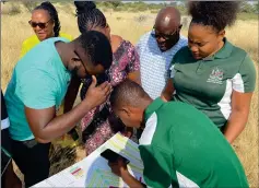  ?? Photo: Contribute­d ?? Land plans… A team of DWN employees on one of the plots to be serviced.