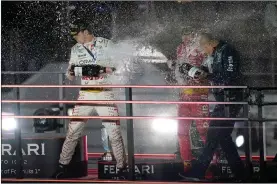  ?? ?? Max Verstappen, left, and Charles Leclerc celebrate on the podium