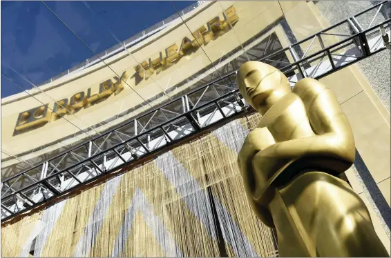  ?? PHOTO BY CHRIS PIZZELLO — INVISION — AP, FILE ?? An Oscar statue at the entrance to the Dolby Theatre in Los Angeles, where the the Oscars will be held tonight beginning at 8p.m. The ceremony will be broadcast live on ABC.