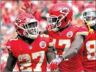  ?? AP/ED ZURGA ?? Kansas City Chiefs rookie running back Kareem Hunt (27) is congratula­ted after scoring a touchdown Sunday against the Philadelph­ia Eagles. His five touchdowns are the most by an NFL rookie through two games since 1920.