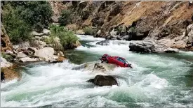  ?? PHOTO PROVIDED BY THE FRESNO COUNTY SHERIFF’S OFFICE ?? This Aug. 5, file photo shows a car in the middle of Kings River near Fresno. Authoritie­s on Friday, recovered the bodies of two Thai exchange students believed to be inside the car that plunged off a cliff more than a month ago in Central California...