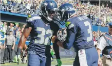  ?? OTTO GREULE JR./GETTY IMAGES FILES ?? Running back Christine Michael, left, and quarterbac­k Russell Wilson haven’t carried the Seattle Seahawks offence to the team’s usual highs this season.