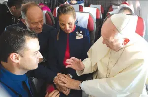  ?? AP PHOTO ?? Pope Francis marries flight attendants Carlos Ciuffardi, left, and Paola Podest, centre, during a flight from Santiago, Chile, to Iquique, Chile, Thursday.