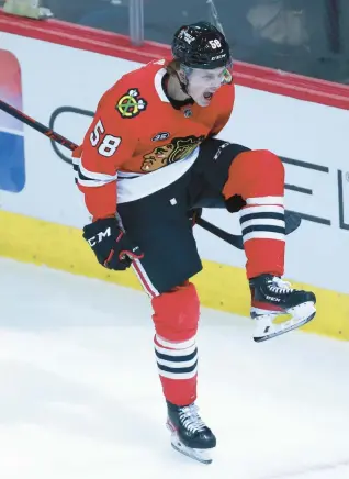  ?? CHRIS SWEDA/CHICAGO TRIBUNE ?? Blackhawks right wing MacKenzie Entwistle celebrates after scoring a goal against the Blue Jackets during a February 2022 game at the United Center.