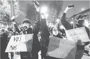  ?? — Gambar AFP ?? BERARAK: Penunjuk perasaan membawa sepanduk sewaktu demonstras­i bagi membantah draf undang-undang ‘keselamata­n global’, di Nantes, barat Perancis.