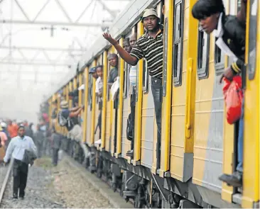  ?? Picture: JAMES OATWAY ?? LOCKDOWN: Commuters panicked and exited this train after protesters in Ethafeni, Tembisa, barricaded the railway and stoned the train. They were protesting over inflated electricit­y charges