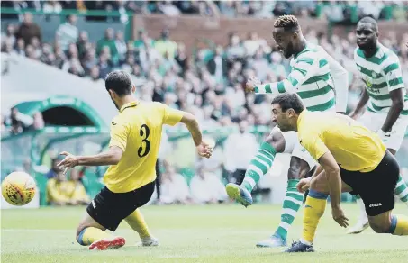  ??  ?? Moussa Dembele hits the first of his double as Celtic beat Alashkert 3-0 to progress 6-0 on aggregate in the Champions League last night.