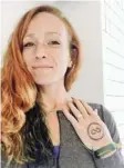  ?? —AP ?? GREENVILLE: In this Nov. 2, 2016, selfportra­it provided by Esther Atkins, the elite marathoner displays a temporary tattoo of the Clean Sport Collective in Greenville, SC.
