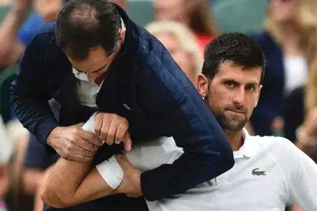  ?? GLYN KIRK/AFP/GETTY IMAGES ?? Novak Djokovic, who was hampered by his right elbow injury throughout Wimbledon earlier this month, is hopeful of returning to the court by January.