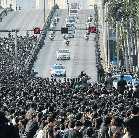  ?? Picture: AFP ?? THE KING AND I: The body of King Bhumibol Adulyadej is transporte­d to his palace in Bangkok, Thailand. Bhumibol, the world’s longest-reigning monarch, died at the age of 88 on Thursday, removing a stabilisin­g father figure from a country where...