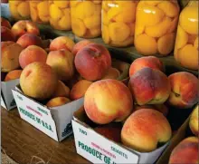  ?? PHOTO BY EMILY RYAN ?? Peaches claim center stage at Highland Orchards’ farm market.