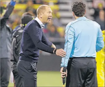  ?? [JOSHUA A. BICKEL/DISPATCH] ?? Crew coach Gregg Berhalter argues a call with a referee during the second half against the Revolution on Saturday.