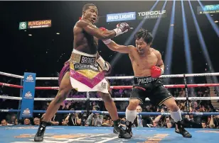  ?? Picture: CHRISTIAN PETERSEN/GETTY IMAGES ?? REACHING OUT: Manny Pacquiao throws a right at Adrien Broner during their WBA welterweig­ht championsh­ip last month. The Philippine master fighter is now doing his best to dissuade his son from taking up boxing.