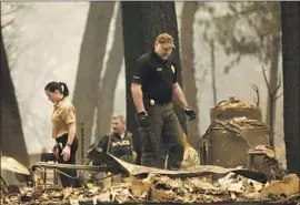  ??  ?? CREWS search for victims of the Camp fire. “The forests are, because of whatever reason ... extraordin­arily f lammable, to put it mildly,” President Trump said.