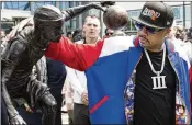  ?? JOSE F. MORENO/THE PHILADELPH­IA INQUIRER VIA AP ?? Ex-76ers star Allen Iverson admires his statue along the team’s Legends Walk, joining the likes of Julius Erving and Wilt Chamberlai­n.