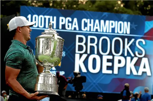  ?? CHARLIE RIEDEL/AP ?? To the victor goes the spoils. Brooks Koepka with the PGA Championsh­ip trophy at Bellerive, Missouri, yesterday.
