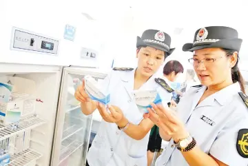  ??  ?? Food and Drug Administra­tion officials check on vaccines for rabies at the Disease Control and Prevention Centre in Huaibei in China’s eastern Anhui province. — AFP photo