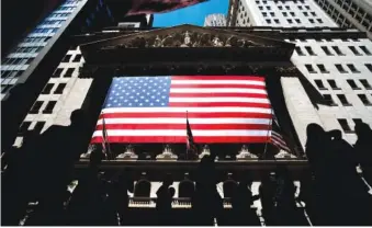  ?? AP PHOTO/JULIA NIKHINSON ?? On June 29, people walk past the New York Stock Exchange in New York.