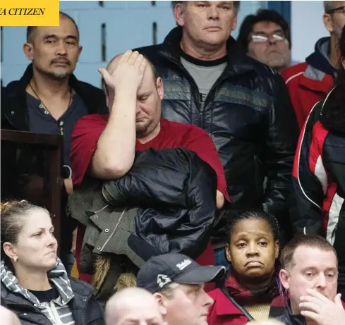  ?? LARS HAGBERG/AFP/GETTY IMAGES ?? A member reacts as union leaders speak at Local 222 in Oshawa, Ont., on Monday, after auto giant General Motors announced it will cut 15 per cent of its workforce to save $6 billion, including the assembly plant that has served as the Toronto-area community’s anchor for decades.