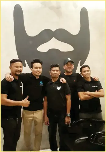  ?? (JO ANN SABLAD) ?? THE OWNERS and the hairstylis­ts of Shave Bar. In the picture is also Francis Casey "Niño" Alcantara, the 26-year-old top-level tennis player, who is the co-owner of Shave Bar.