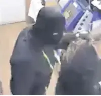  ??  ?? Terrifying Thug grabs worker and forces her to try the till